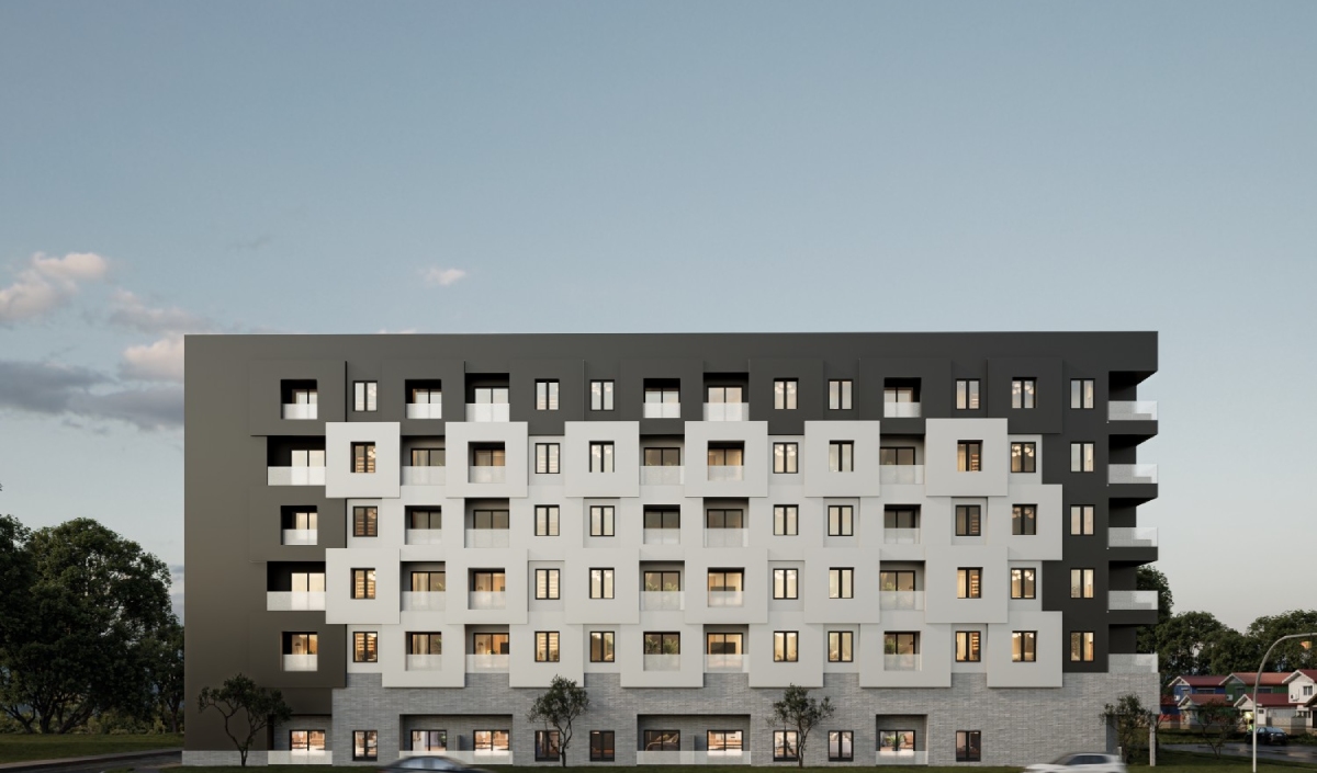 A modern six-story apartment building with a geometric facade featuring black, white, and gray panels, several balconies, and lit windows at dusk.