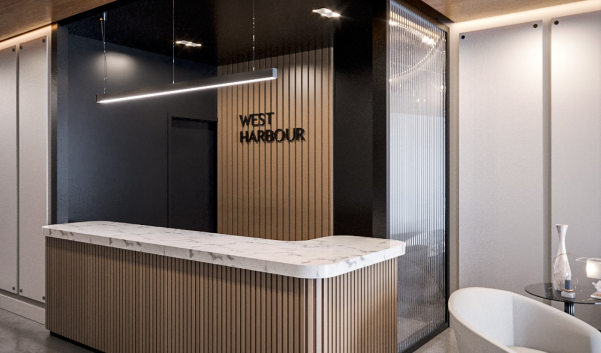 Modern reception area with a marble counter, wood paneling, a minimalist light fixture, and a sign reading "West Harbour" on the wall.