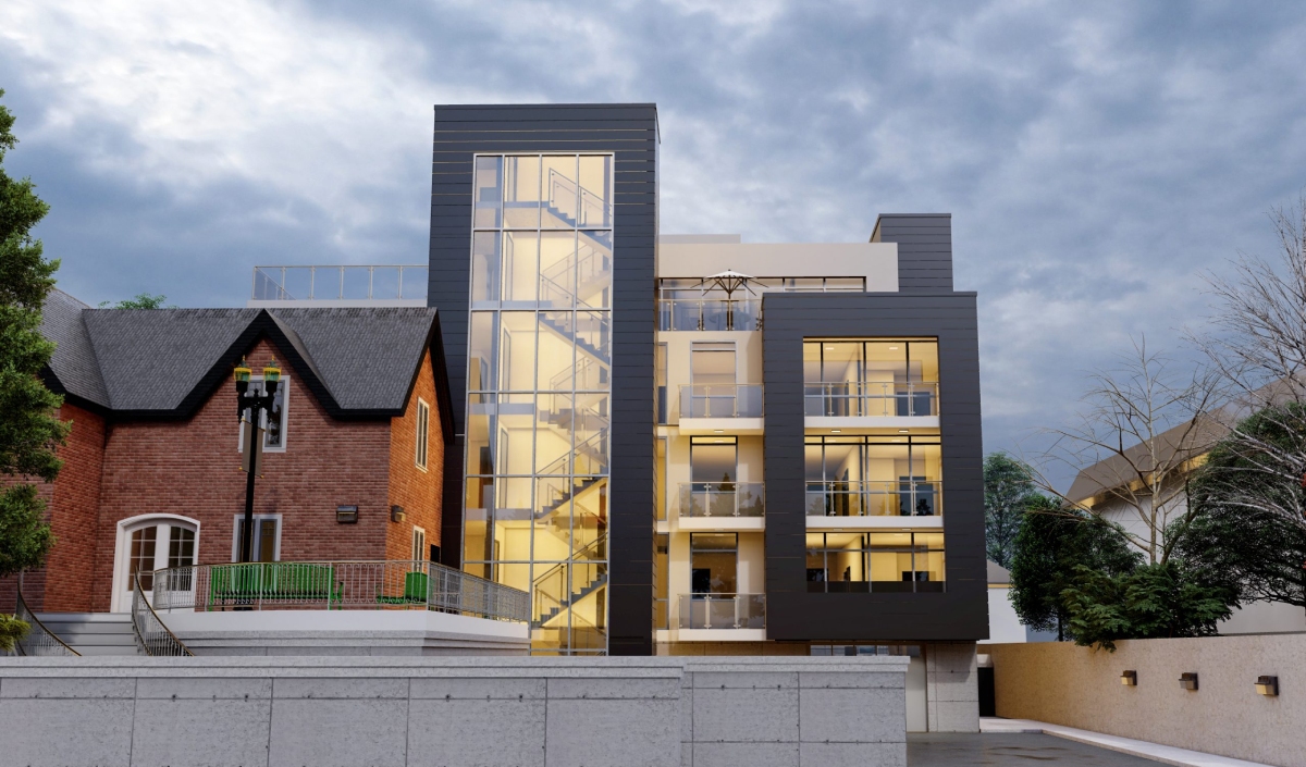 Modern multi-story building with large glass stairwell sits next to a traditional brick house at 1269 Mohawk Road, both under a cloudy sky, with trees and a concrete wall in the foreground.