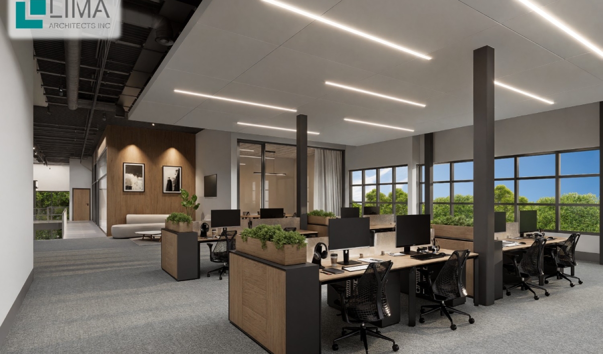 Modern open-plan office space with desks, computers, chairs, and plants. Large windows bring in natural light. LIMA Architects Inc. logo visible in the top left corner.