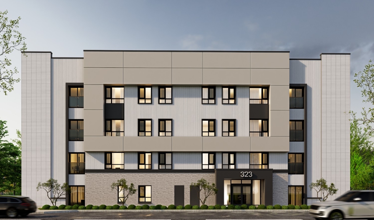 Modern four-story apartment building with a flat roof, large windows, and the number 323 above the entrance; located near the Richemont Office, with cars passing in front on the street.